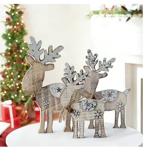 Set of three rustic wooden reindeer Christmas table ornaments with bells