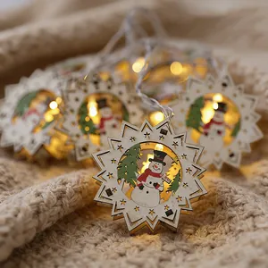 Warm glow Christmas wooden snowflake string lights with cute snowman and tree design