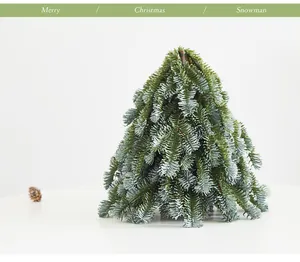 Close-up of a mini PE faux Nobilis fir Christmas tree for desktop decoration