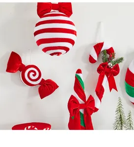 Detailed close-up view of red and white striped velvet Christmas candy ornaments with bows