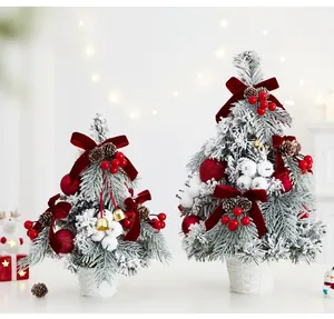 Detailed view of two flocked Christmas trees with red velvet bows and golden bells