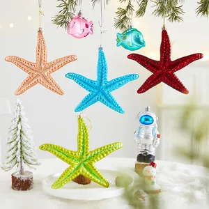 Colorful Christmas ornaments set featuring starfish and astronaut figures on a pine tree