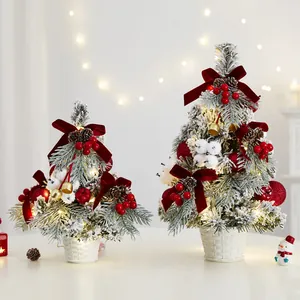 Elegant flocked mini Christmas trees with warm LED lights and red velvet bow decor