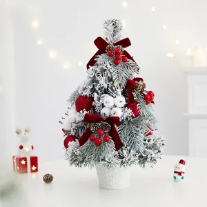Exquisite flocked tabletop Christmas tree with red velvet bows and berries for festive decor