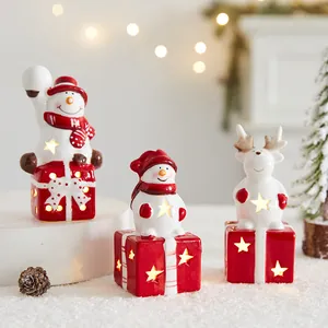 Dekoset mit drei warm leuchtenden Keramik-Weihnachtsfiguren Schneemann und Rentier