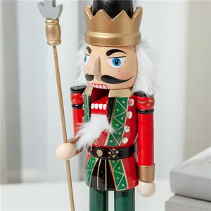Detail view of a 38cm wooden Nutcracker soldier puppet with golden crown and spear