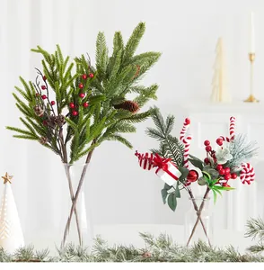 Detail view of festive artificial pine branches with red berries and candy canes