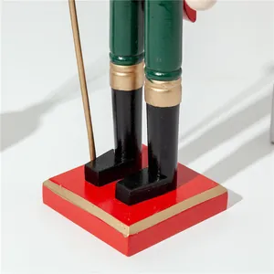 Detailed close-up view of a wooden nutcracker soldier red base and black boots