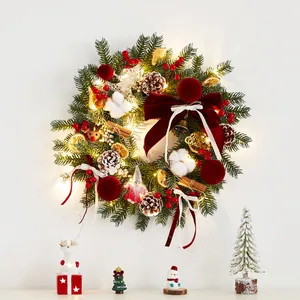 Illuminated Christmas wreath with wine red velvet bow and ornaments for door decor
