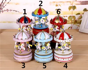 Multiple vintage clockwork carousel music boxes displayed in various vibrant colors and patterns