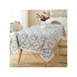 Elegant cotton linen tablecloth with blue floral pattern and delicate lace trim.