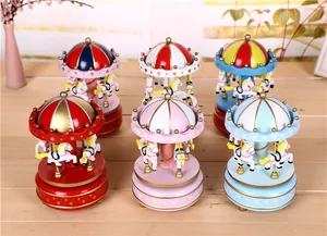 Detailed view of colorful wind-up carousel music boxes in various festive designs