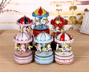 Detailed macro view of vintage wind-up carousel music boxes in several vibrant colors