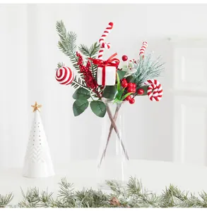 Festive Christmas arrangement featuring red berries and pine branches in a vase.