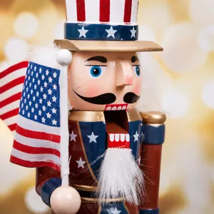 Macro shot of a wooden American soldier nutcracker's face and miniature US flag
