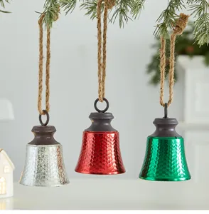 Set of three rustic Christmas bells with hammered metal texture and natural twine hanging ropes