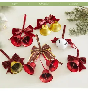 Detailed view of festive red and gold Christmas metal bells decorated with elegant velvet bows