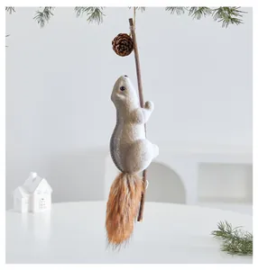 Detailed view of plush squirrel Christmas ornament with fluffy tail and pine cone