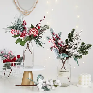 Artificial Christmas pine branches with red berries and candy canes for table decor