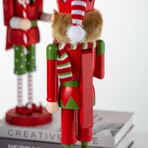 Close-up back view of a 38cm wooden nutcracker elf with red scarf and hat details