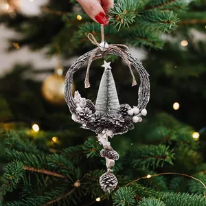 Festive Christmas wreath ornament with pinecones and mini trees for holiday decor