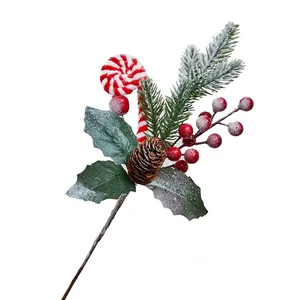 Festive Christmas decorative sprig with red berries, frosted pine branch, and candy cane