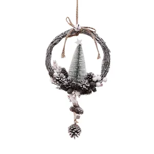 Handcrafted rustic Christmas wreath hanging decoration with pinecones and a mini tree