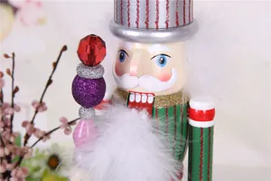 Detail view of a colorful wooden Nutcracker puppet with white faux fur and festive scepter.