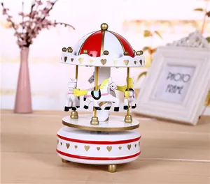 Exquisite wind-up carousel music box featuring a red and white dome and gold hearts