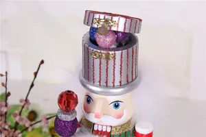 Detailed close-up of a 38cm wooden Nutcracker puppet with glittery gift box hat