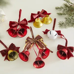 Decorative Christmas iron bells with velvet bows and printed ribbons for holiday hanging