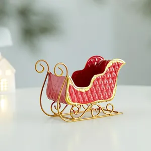 Festive red and gold iron Christmas sleigh ornament for holiday desktop decoration