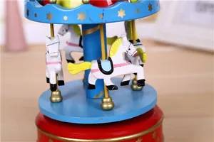Detailed close-up of a colorful wooden wind-up carousel music box with white horses.