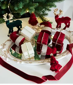 Burgundy velvet Christmas ornaments with reindeer, Santa hats, and gift box shapes