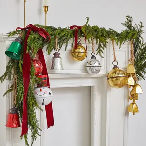 Assorted vintage metal Christmas bell ornaments with Merry Christmas for holiday decor