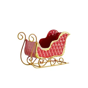 Vintage red iron Christmas sleigh ornament with gold scroll base for festive decor