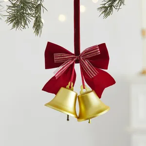Golden Christmas bell hanging ornament with red velvet ribbon bow for festive decor
