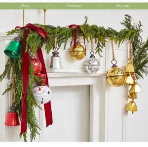 Detailed view of creative Christmas iron bells on a festive fireplace mantel