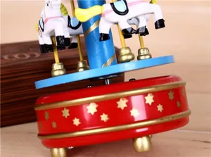 Detailed macro view of a colorful wind-up carousel music box with golden star patterns