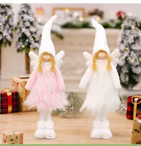 Detailed shot of pink and white plush Christmas angel dolls in a festive setting