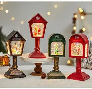 Group of four vintage-style Christmas snow globe lanterns with festive figurines
