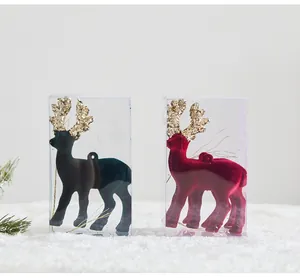 Set of velvet Christmas reindeer ornaments in clear boxes with gold glitter antlers