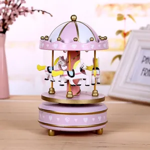 Elegant pink carousel music box featuring white horses and golden accents for gifts