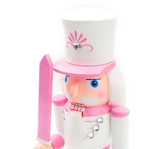 Close-up of a pink and white wooden nutcracker soldier with sparkling jewel details.