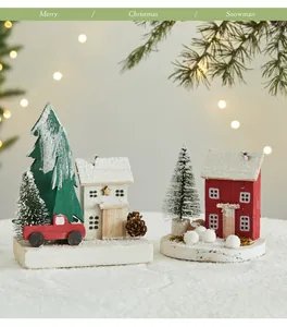 Handcrafted wooden Christmas cottage scenes with snow-covered trees and ornaments