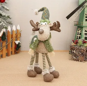 Detailed view of plush reindeer Christmas decoration with long striped legs and green hat