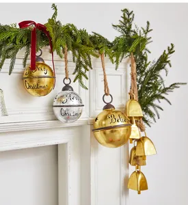 Macro detail of golden and silver Christmas jingle bells with Merry Christmas engravings