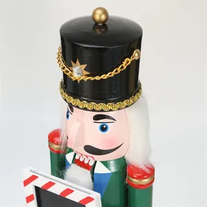Close-up detail of a 38cm wooden Nutcracker soldier holding a striped picture frame