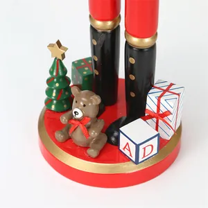 Close-up detail of a wooden Christmas Nutcracker base with miniature gift decor