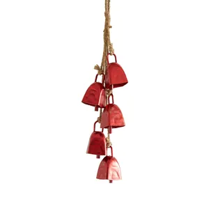 Rustic red metallic Christmas bells hanging on jute rope ornament for holiday decor